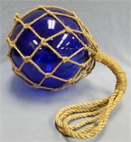 New cobalt blue glass fishing float with netting,