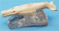 Moose antler carving of a whale on raw, quartz sla