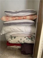 Stack of sheets, pillows, comforter