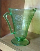 Lime green depression glass pitcher has a crack