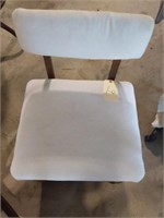 White roll around padded chair with storage