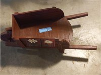 Small wooden wheelbarrow with flower painting on