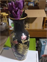 Tall floral black vase with purple tulips inside