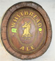 Advertising sign in shape of barrell end -