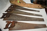 Four  hand saws in canvas carrier