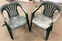 Two green plastic outdoor chairs