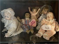 Shelf of Assorted Dolls