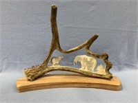 Moose antler carving of a mother bear with a fish