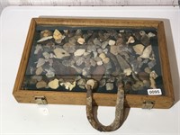 Display box full of flint rock and arrowheads