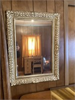 Plastic wall hanging mirror, has small crack/hole