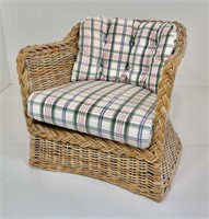 Single natural wicker arm chair, plaid cushions.