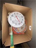 box with thermometer, cord, etc