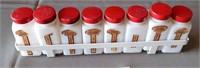 911 - VINTAGE MILK GLASS SPICE JARS IN RACK