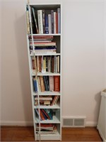 White tall book shelf  with misc books