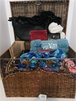 Wicker basket with scarfs, handbags and wallets