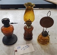 3 old oil lamps with amber glass