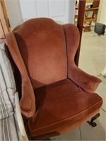 Red wing back chair worn