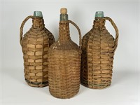 3 large wicker wrapped glass bottles