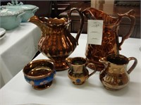 Four TOC copper luster jugs along with a salt