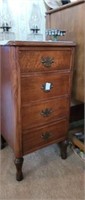 Small wood 4 drawer cabinet. Measures about 30in