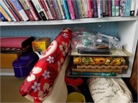 Shelf of sewing supplies and pamphlets. Includes