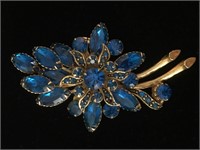 GOLD FLORAL BROOCH WITH BLUE RHINESTONE;  COSTUME