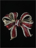 RED AND GOLD BOW BROOCH;  HAS SMALL CLEAD