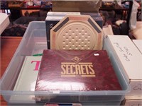 Container of games and puzzles including Secrets,