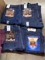 Four pair of carpenter pants three Carhart one