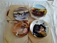 Four vintage collector plates.