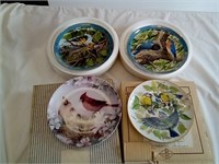 Four pretty bird theme collector plates.