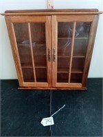 17 x 16 x 2 1/2" wood cabinet with glass in doors