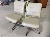 2 matching swivel caste red game chairs,