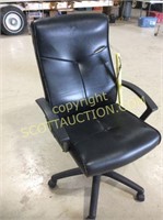 Black vinyl executive swivel office chair, seams