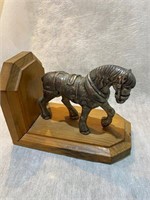 horse made from white metals with wood stand
