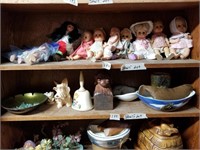 Shelf lot with different dressed dolls most are th