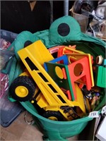 Vinyl bag full with kids toys, plastic trucks, fis