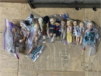 Shelf lot with mini dolls in plastic bags most the