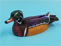 Colored scrimshaw ivory carving of a wood duck by