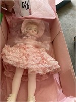 Doll in pink dress in box