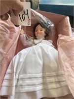 Doll in white dress in box