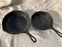 Two cast-iron pans one measures 9 inches the