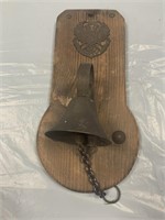 SMALL TIN DECORATIVE BELL ON WOOD