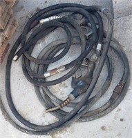 Two Gas Pump Nozzles and Two Hoses.  One Hose
