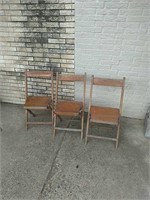 Three wood folding chairs