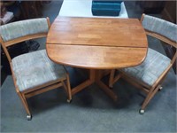 Drop leaf oak table with 2 chairs on rollers