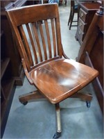 Antique wood desk chair on rollers