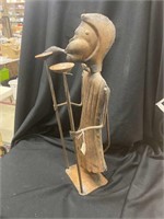 A metal monkey candle holder. 21 inches tall