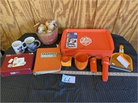 10 orange food trays, flash lights, coffee mugs, a
