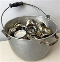 Aluminum pot full of canning jar lids